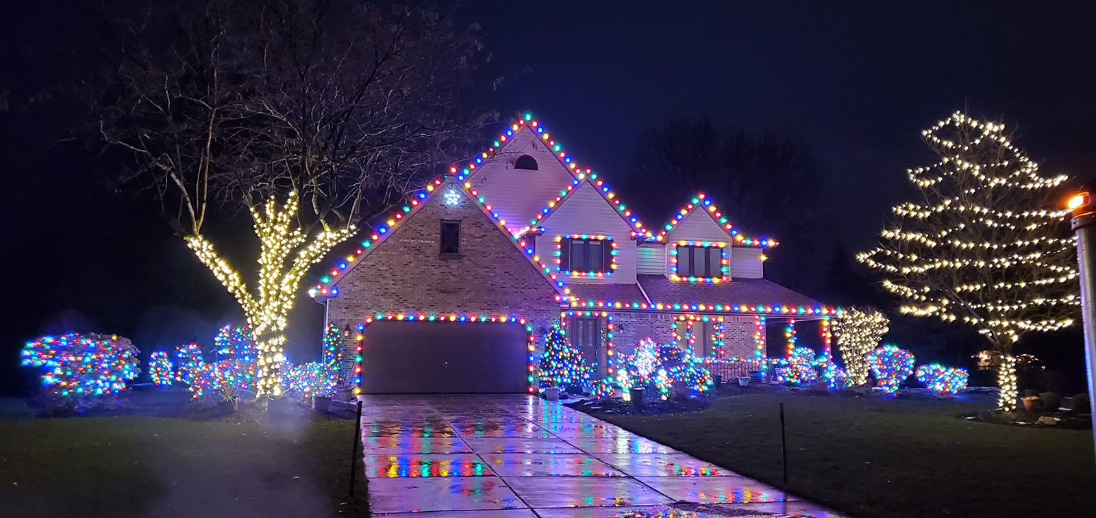 Colorful holiday lighting display by S&K Holiday Lighting